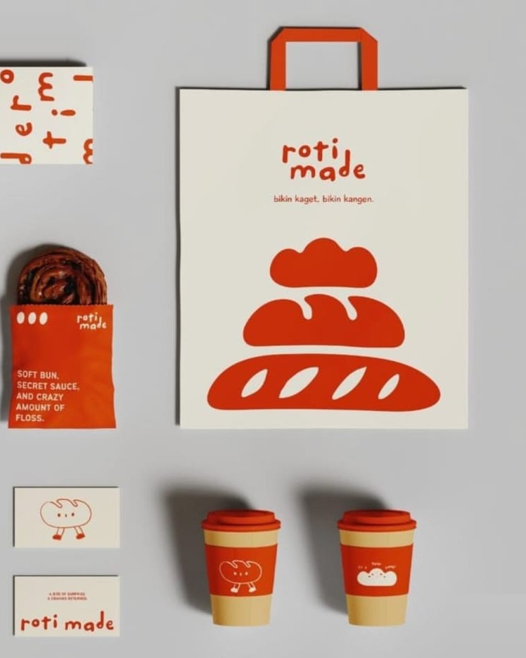Sacola, copos e cartões em vermelho e off-white, com ilustrações de pães